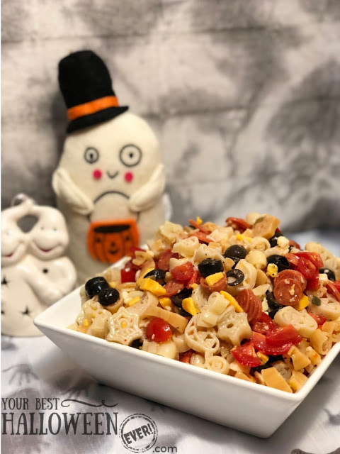 bowl of spooky noodle pasta salad with ghost figures in background, best easy Halloween pasta salad recipe